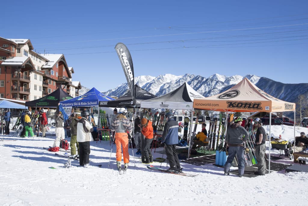 skiers and boarders check out all the tents and demos available on the beach!