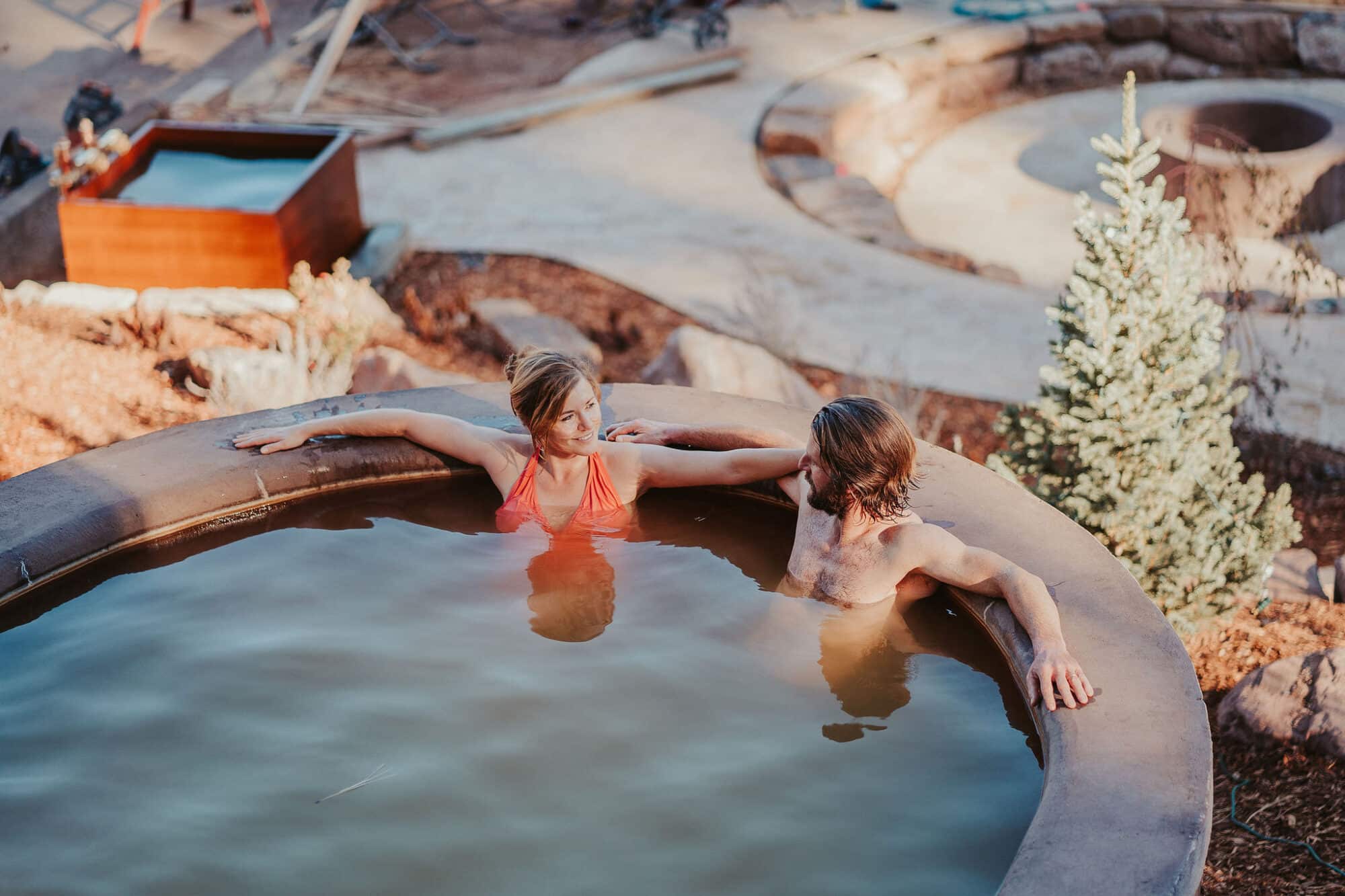 A couple soaks in a pool at Durango Hot Springs
