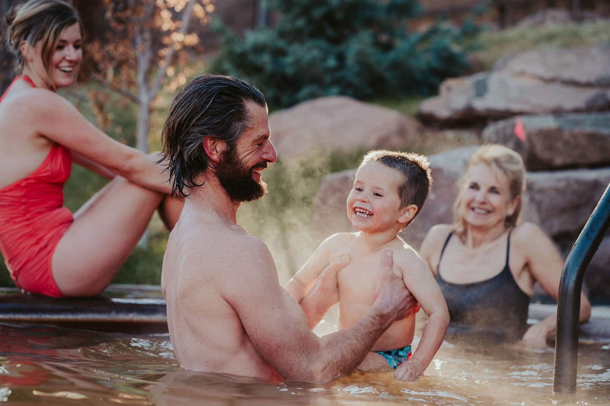 A father and son enjoy the warm waters at Durango Hot Springs