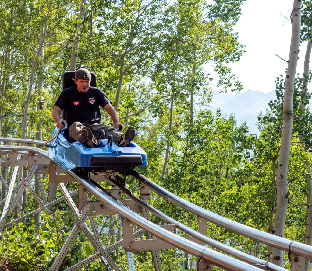Employee riding the mountain coaster