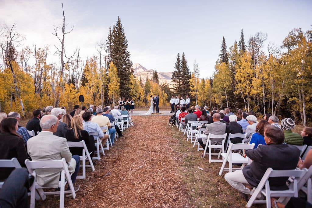 Love ones in attendance watching the bride and groom get married at the Engineer ceremony site during autumn