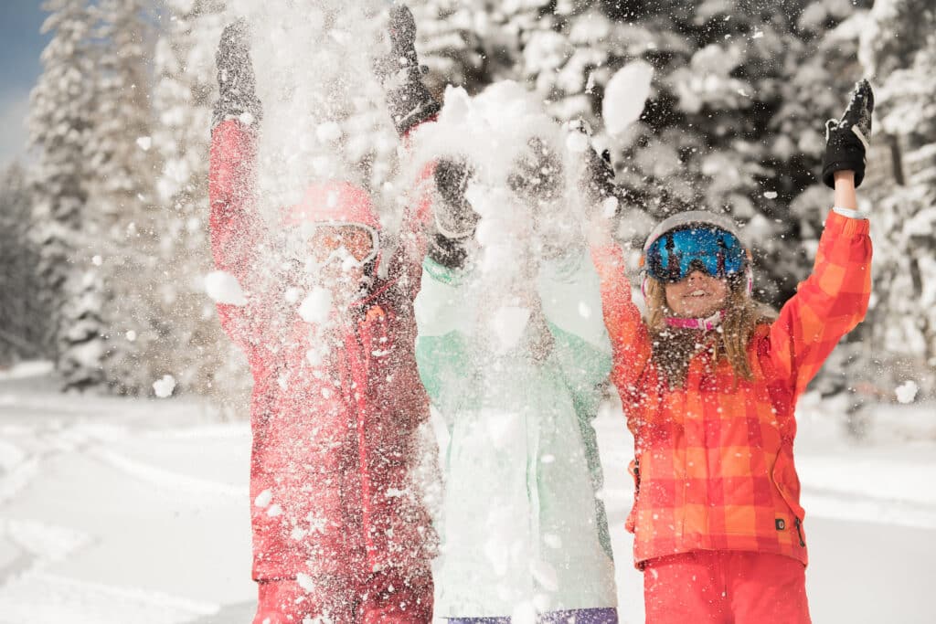 girls playing in the snow