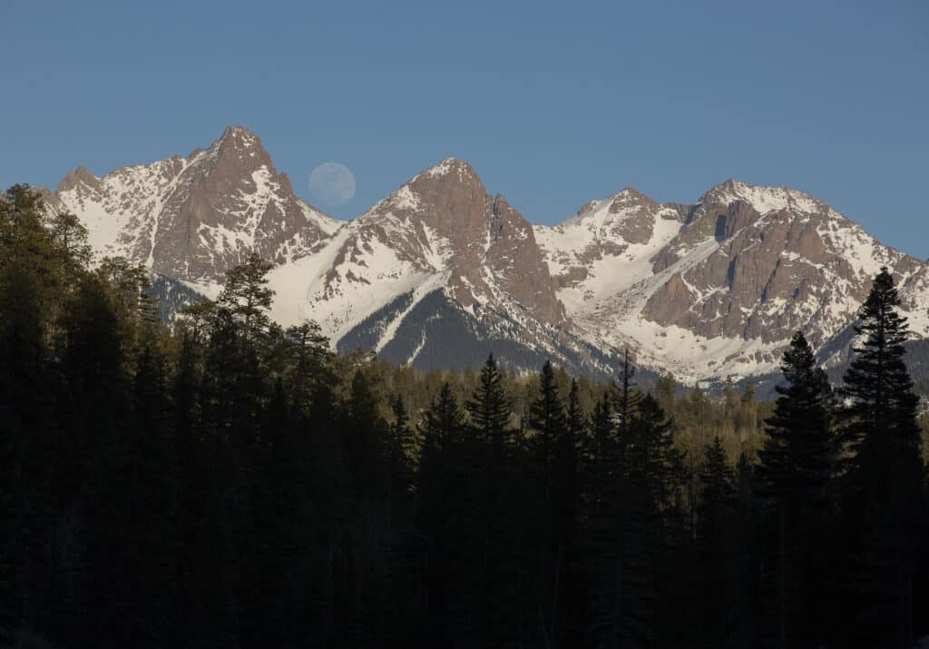 The moon rises over the needles mountains