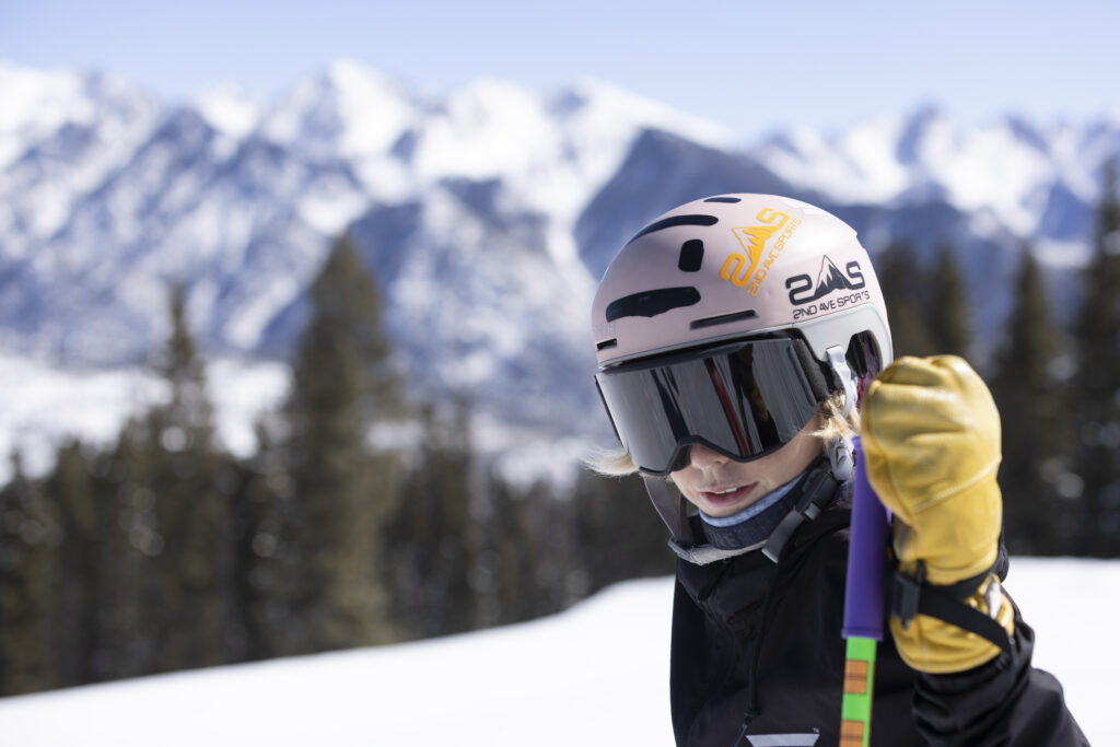 Teenage skier poses with the Needles Mountain Range softly in the background