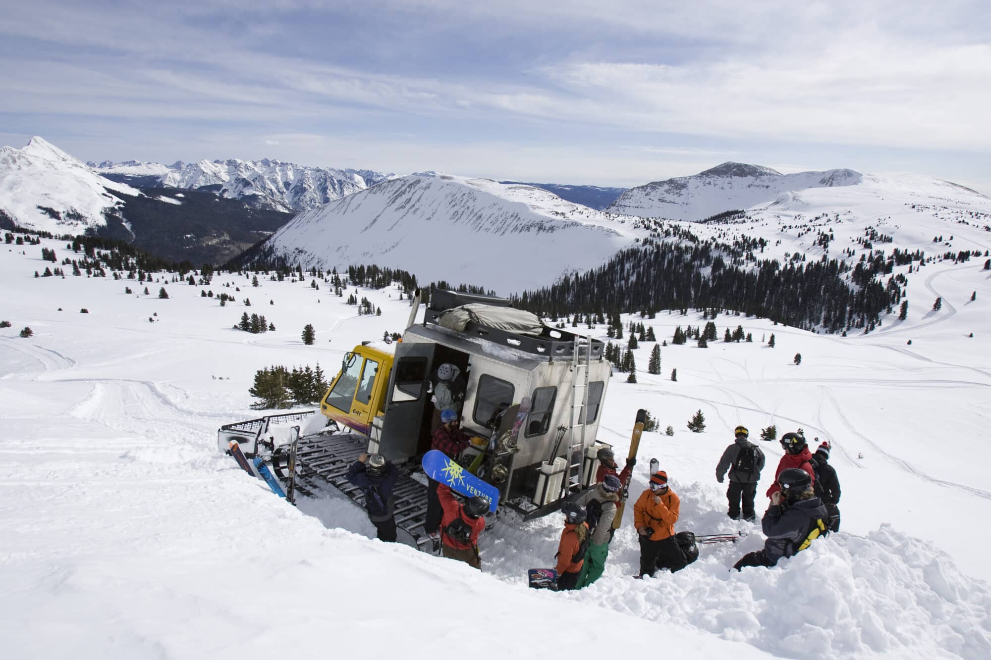 Group unloads the snowcat and looks out at the vast amount of terrain