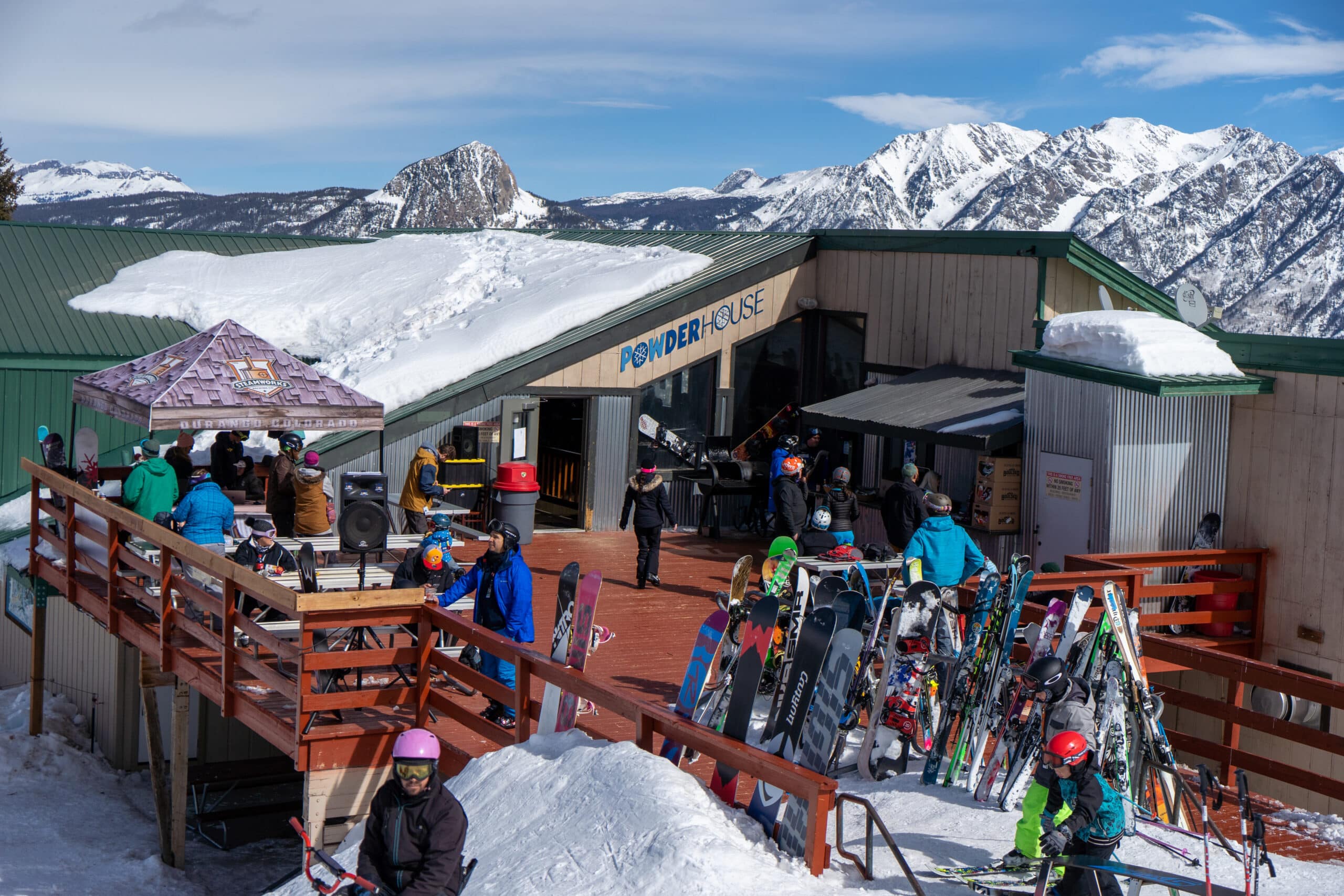 People gather for drinks on the patio at the Powderhouse