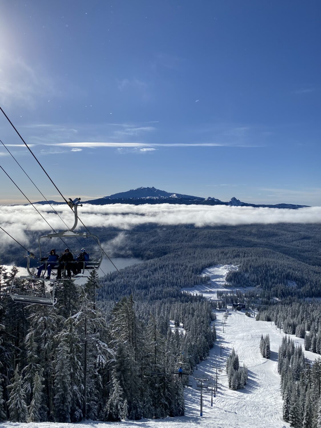 Skiers and snowboarders ride the lift at Willamette Pass Resort