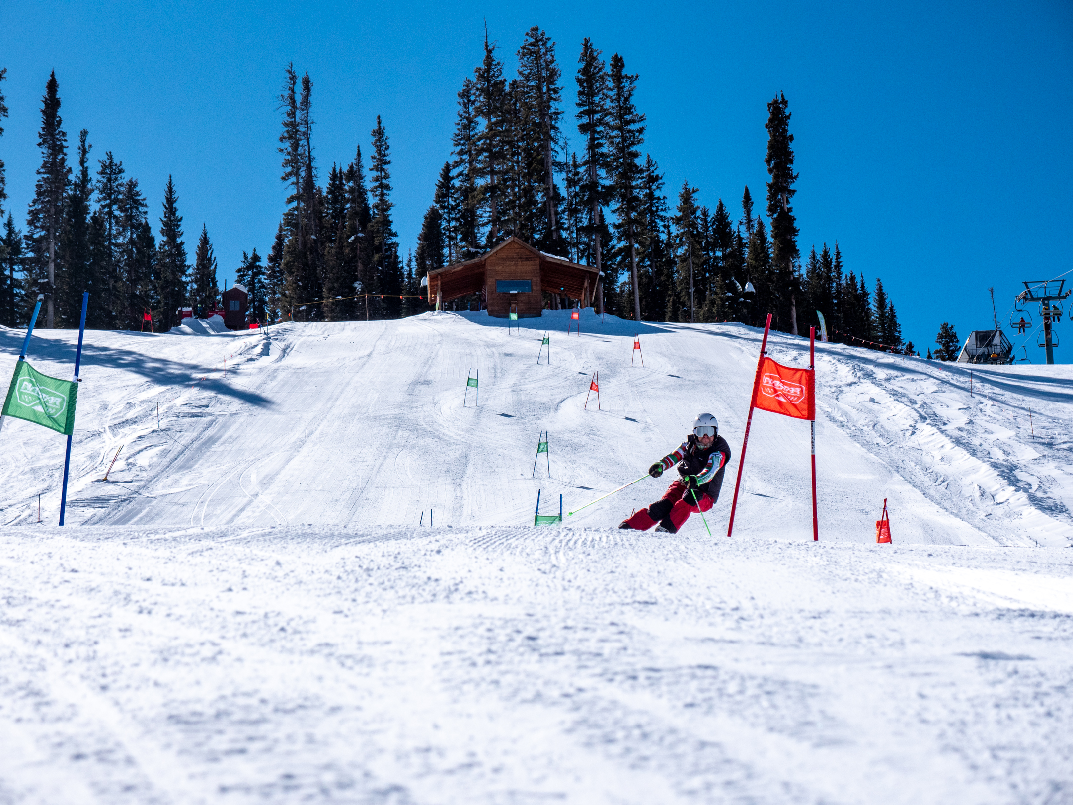 A skier leans into the turn as he races down a slalom course