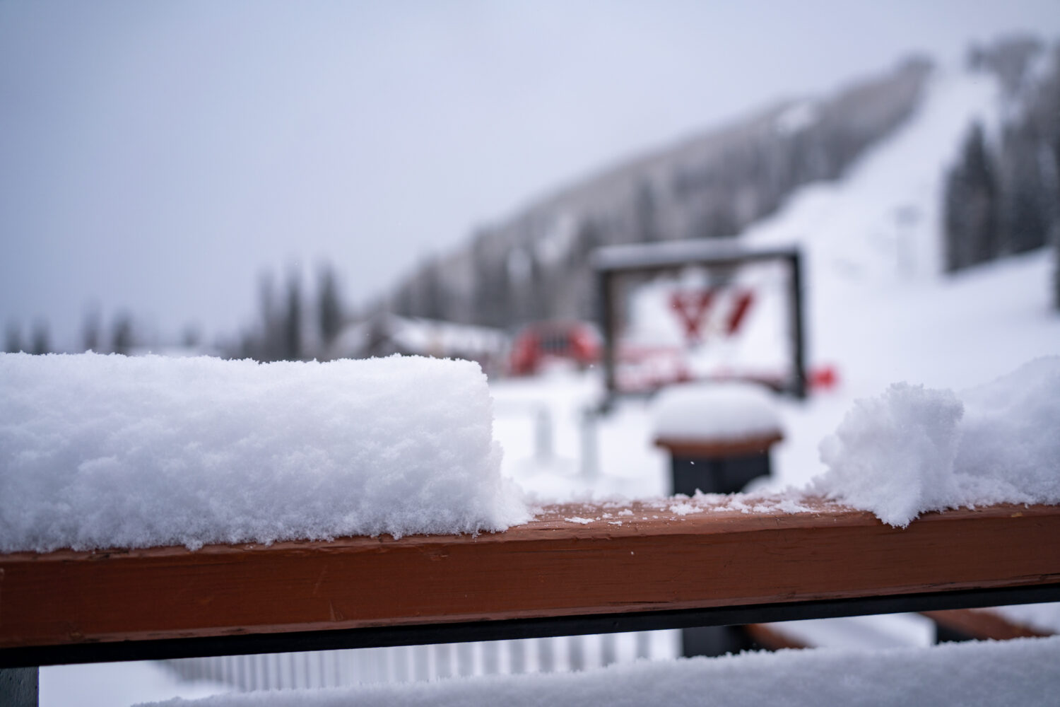 The Purgatory sign is visible through a notch in the snow built up on a hand rail