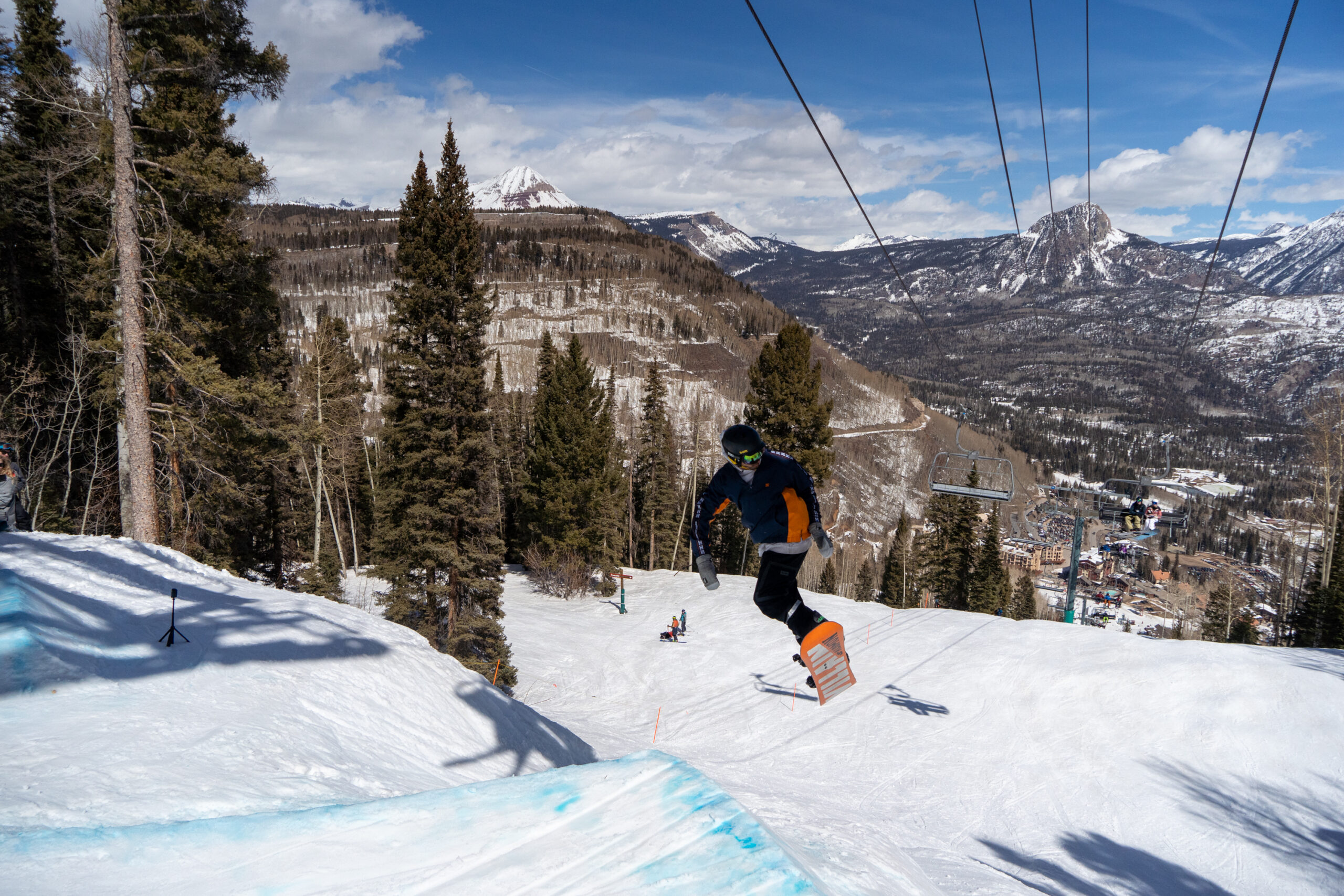 A snowboarder catches air off a feature during the Hollywood Huckfest event