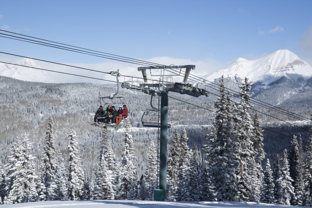 Skiers and Snowboarders ride the chairlift