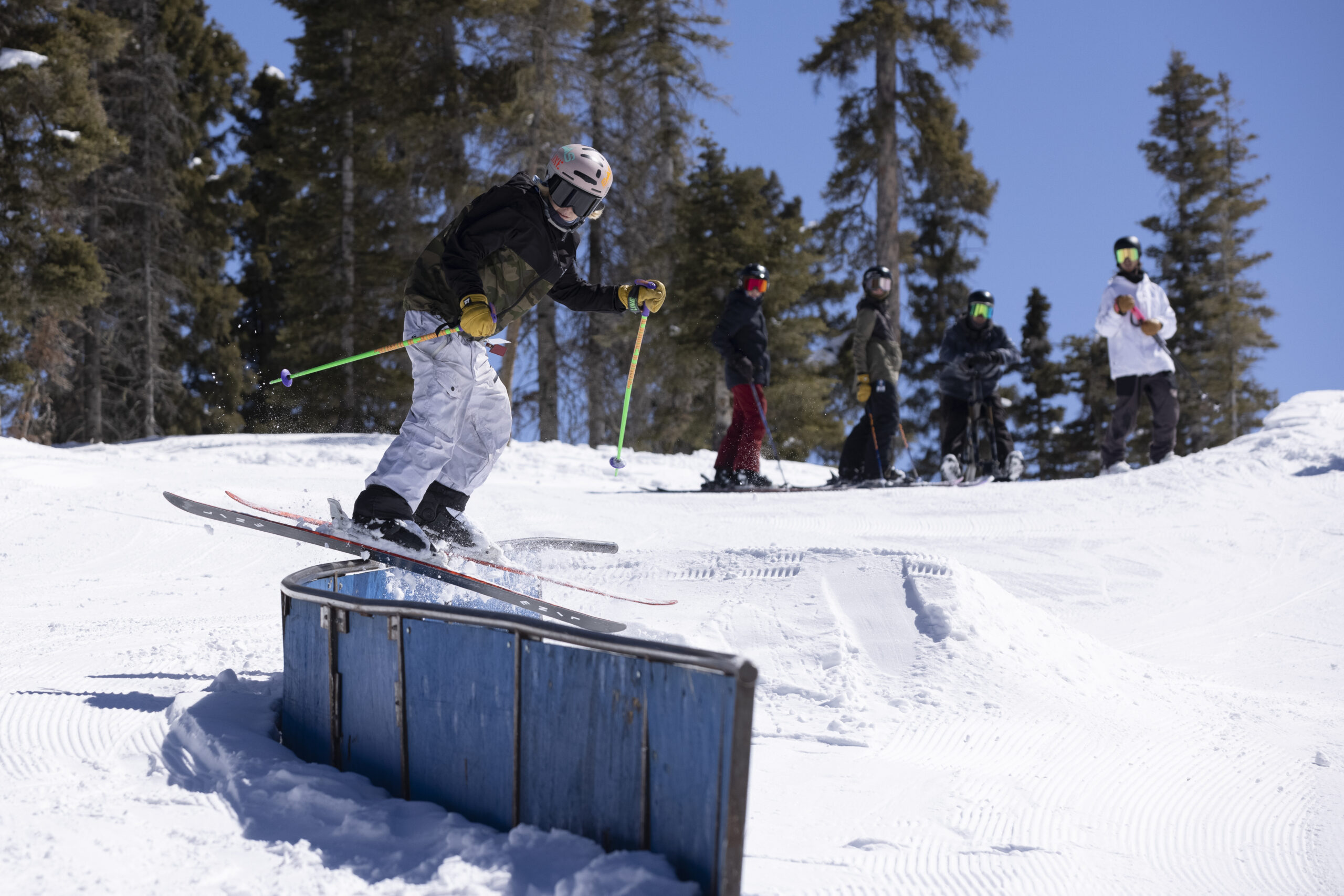 A skier slides along the rails during a rail jam competition