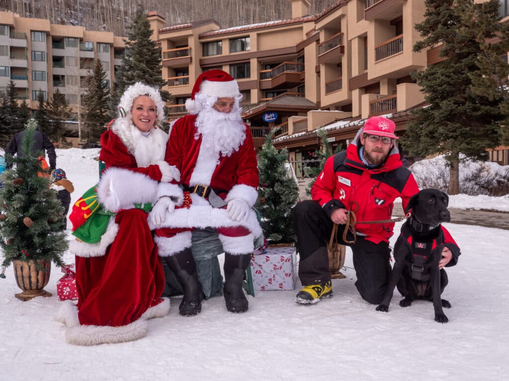 Santa and Mrs. Claus with ski patroller