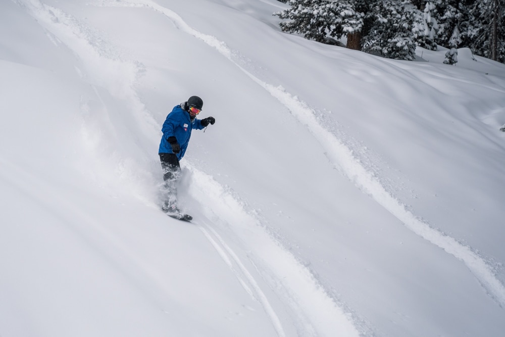 Snowboarder riding powder