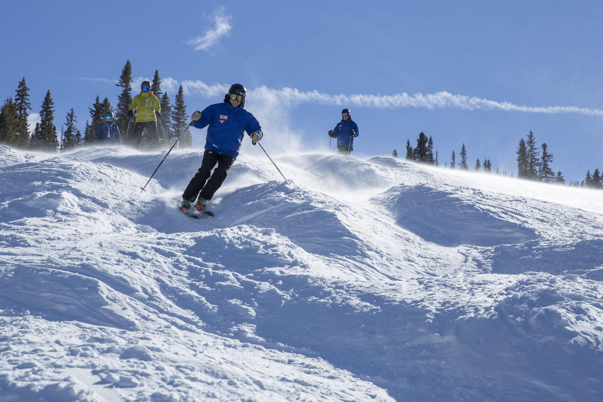 Group skiing moguls