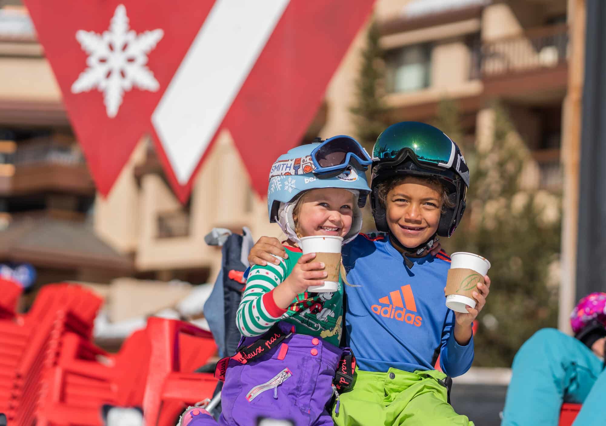 Two kids sipping hot chocolate