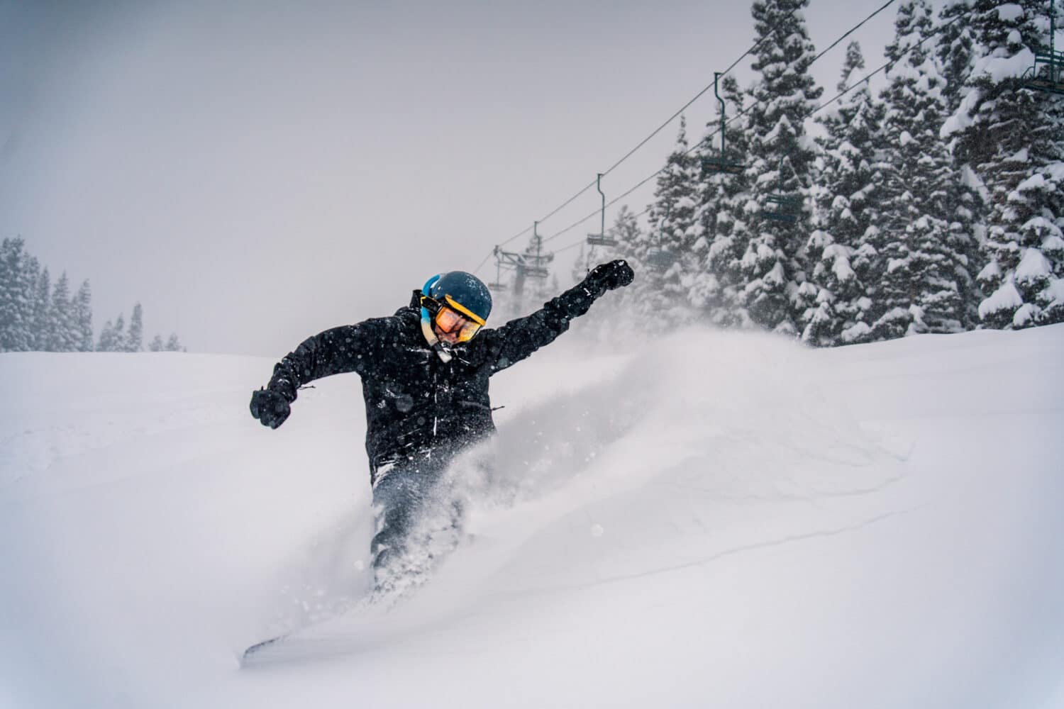 A snowboarder wears a snorkel in deep powder