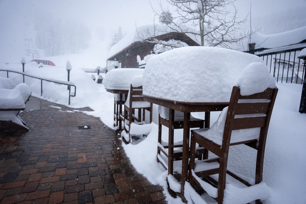 snow piles up on a table during a powder day