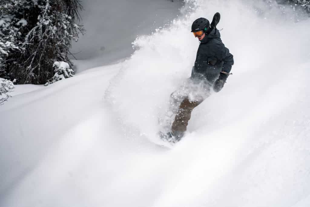Snowboarder riding on fresh powder