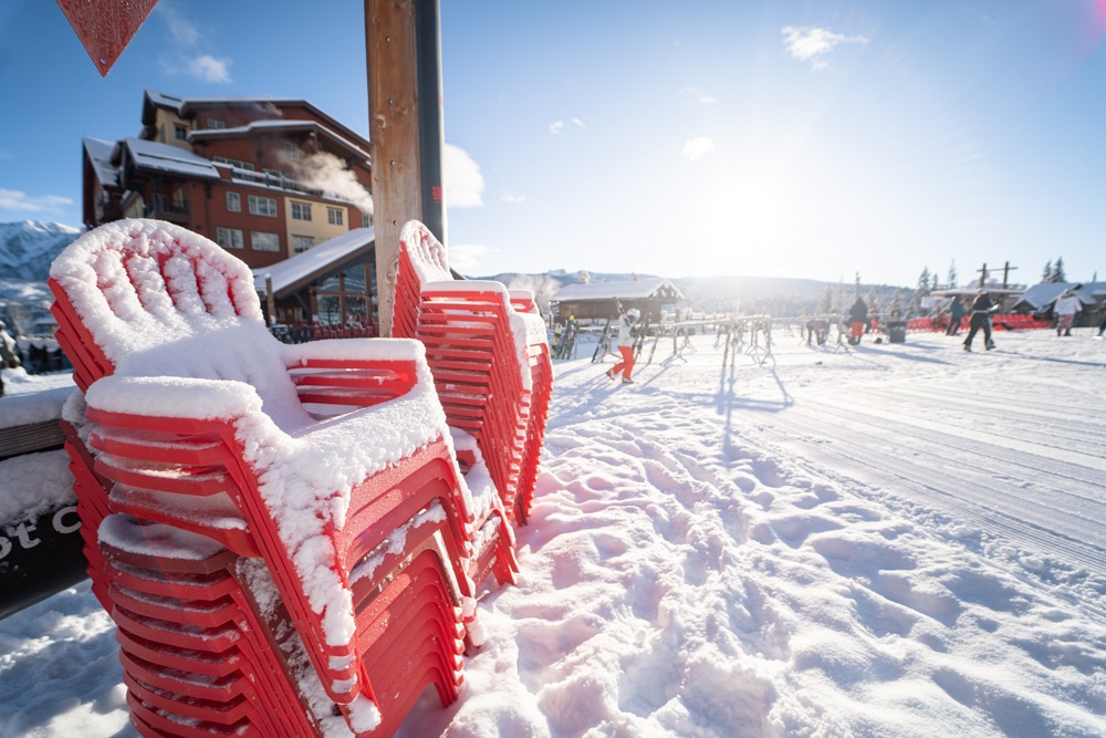 Red chairs covered in snow