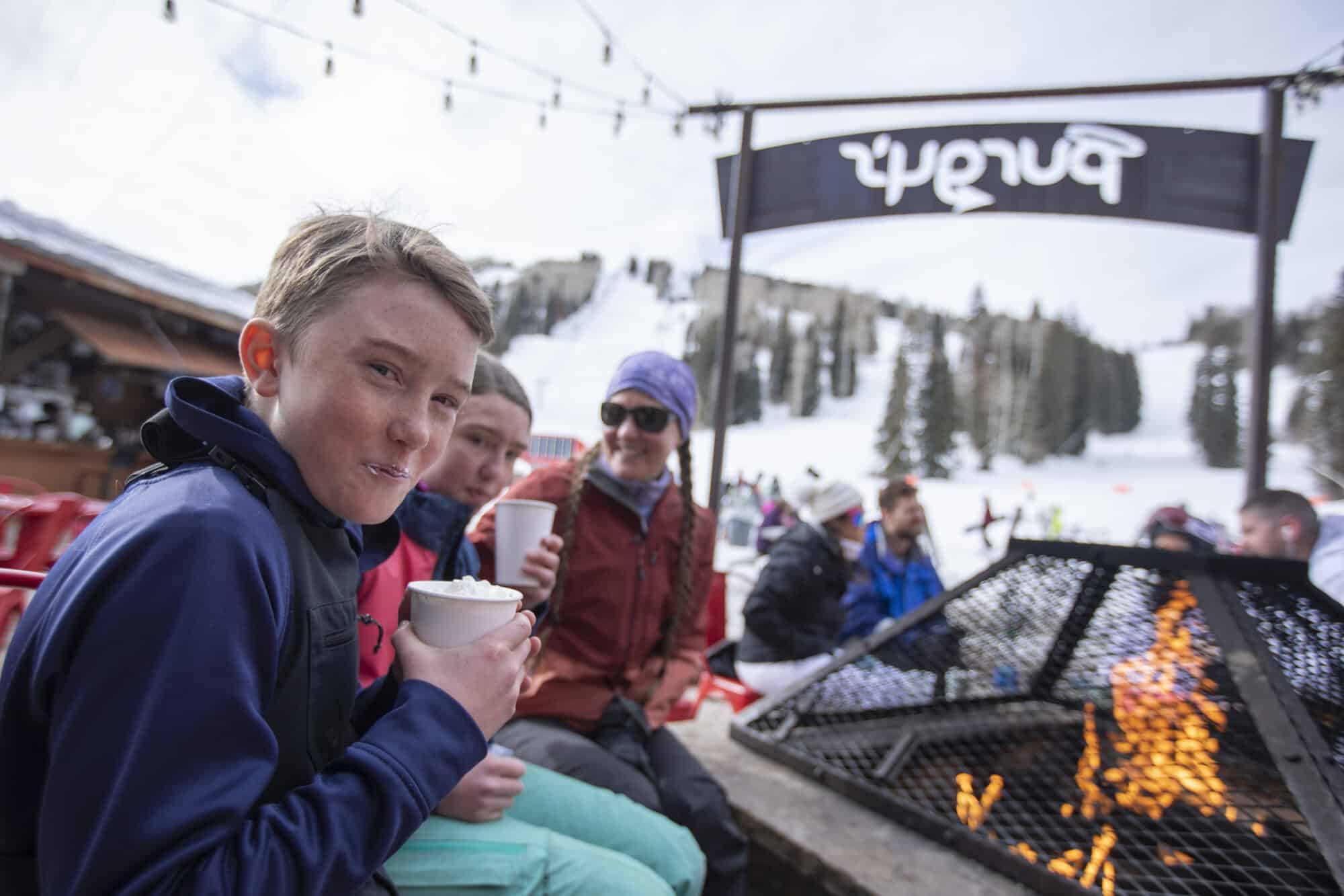 Kid warming up by cozy fire