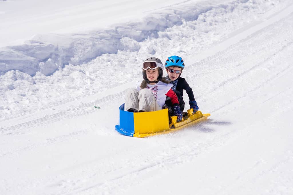 Two kids on their colorful cardboard derby