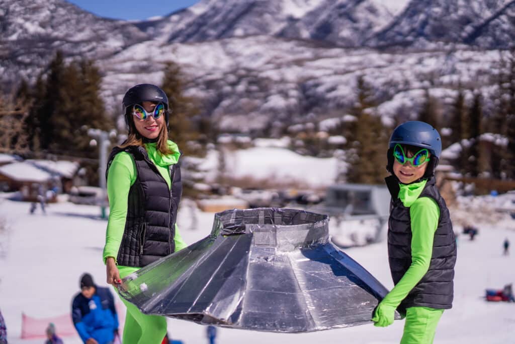 Mom and kid showing off their cool derby racer