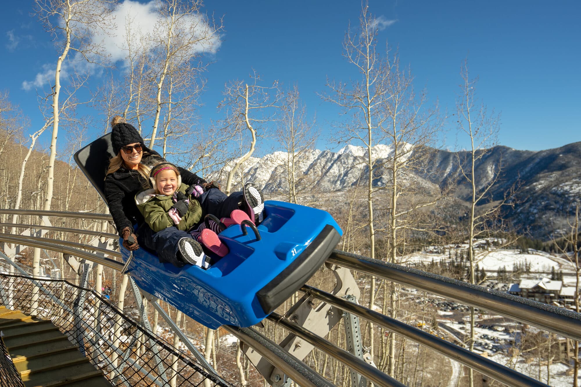 Women and her kid on mountain coaster