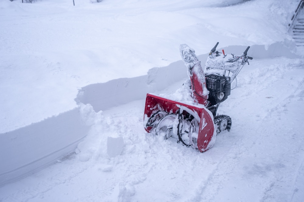 snow machine clearing a path in the fresh snow