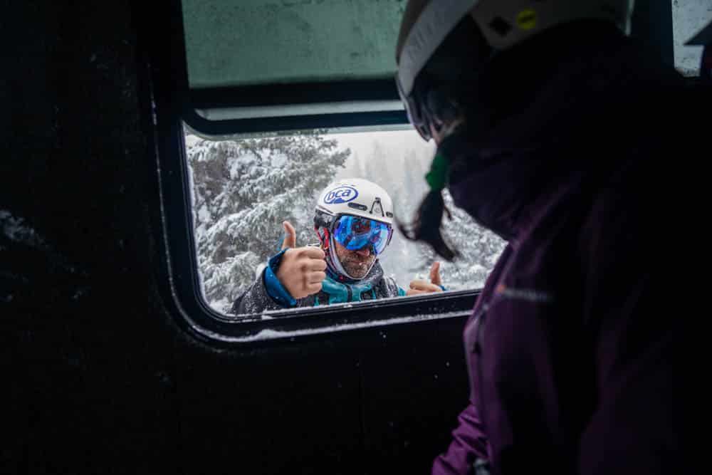 Skier enjoying their break in the warm and comfy snowcat
