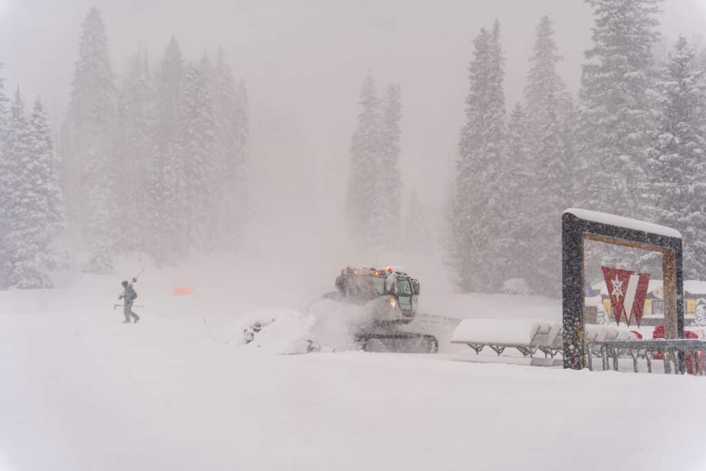 Snowcat working hard during a a snow storm