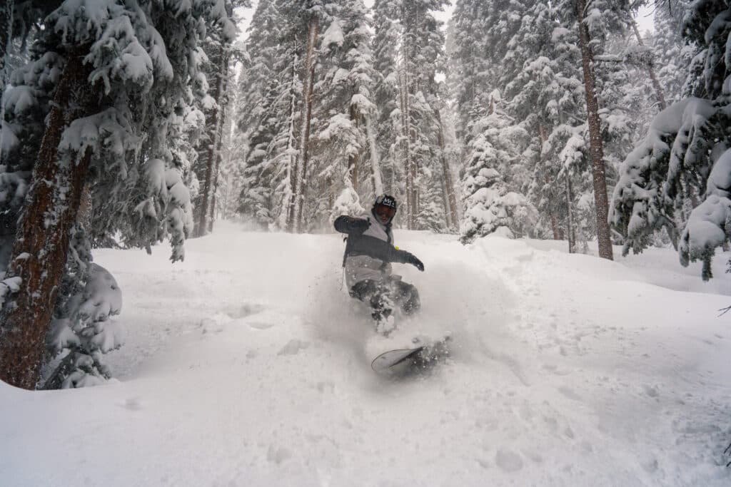 Snowboarder making turns in fresh powder