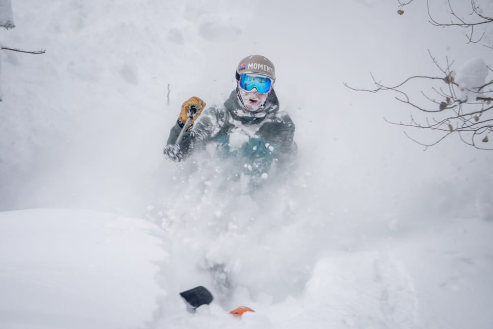 A man skis through deep powder