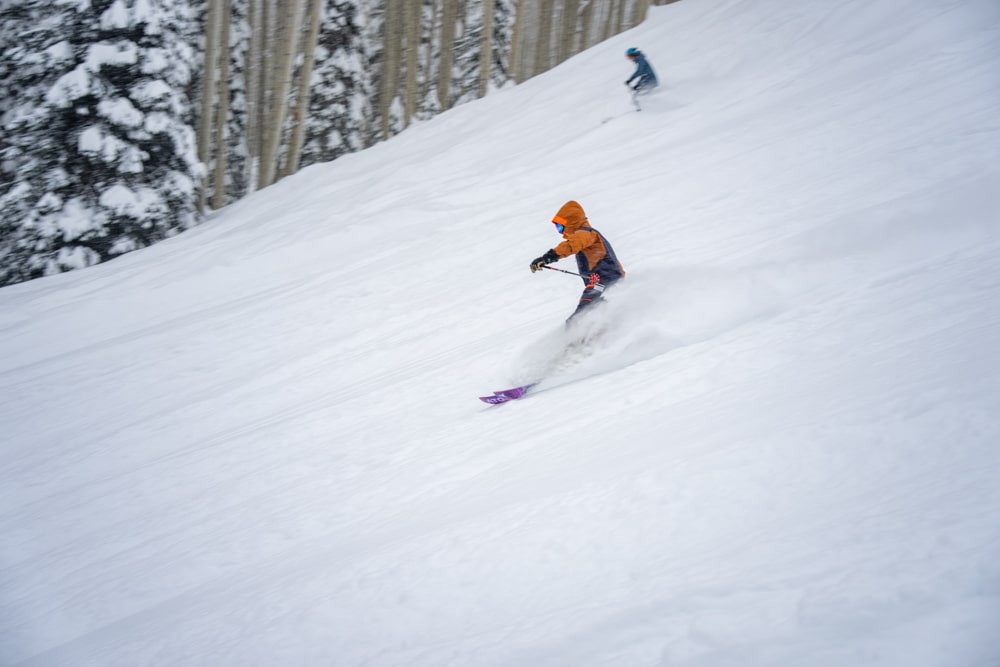 A skier shredding powder