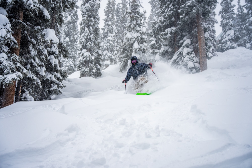 A skier navigating through the trees