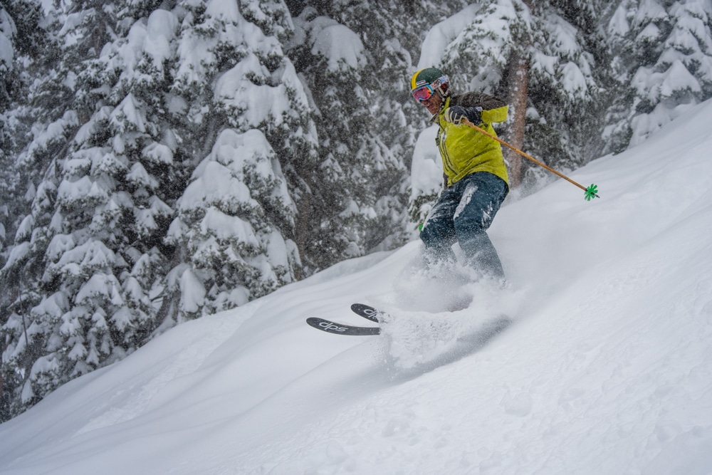 A skier makes his way down the powder