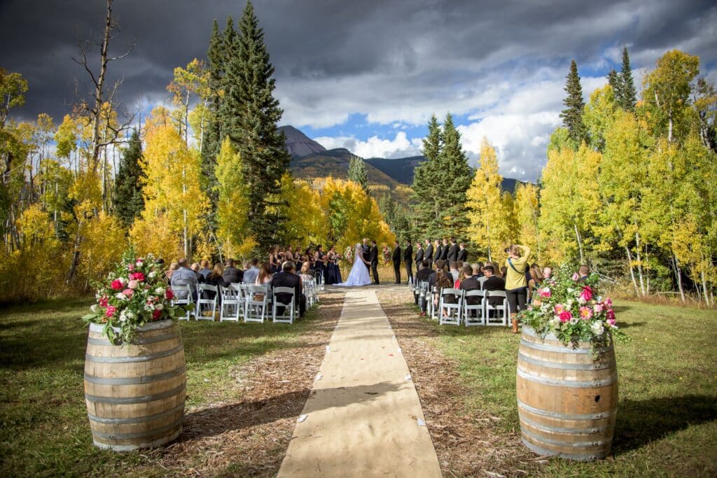 A wedding on an autumn day with mountains in the background