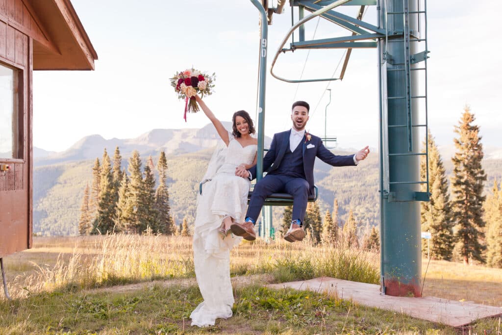 A bride and groom on a ski lift