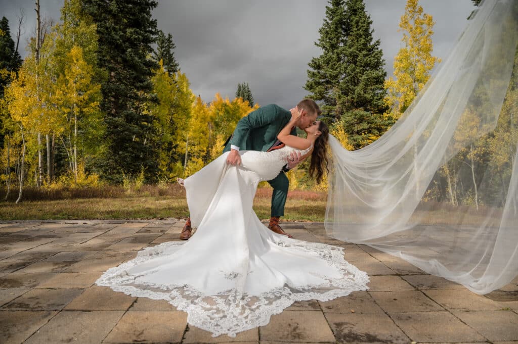 A groom dips the bride for a kiss