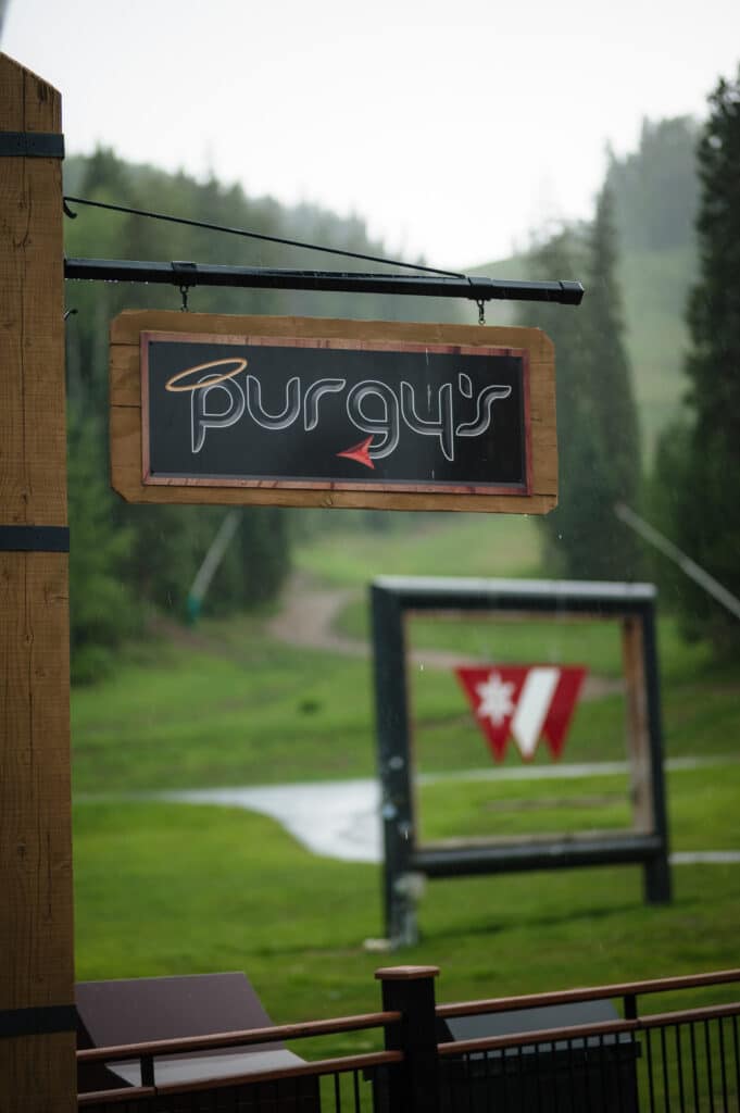 Purgy's sign with purgatory logo in the background