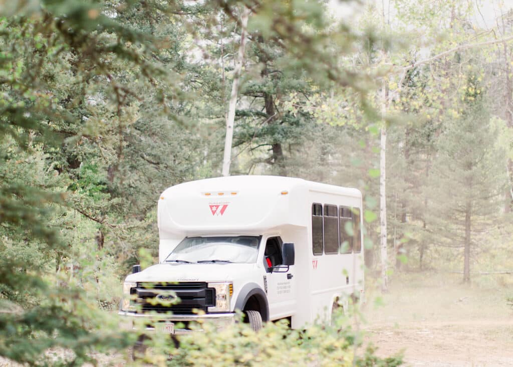 The Purgatory Shuttle drives on a forest service road to the Engineer ceremony site