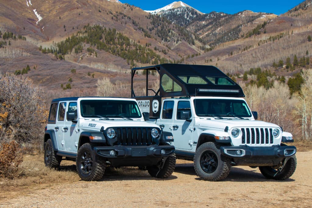 Two white jeeps in the mountains