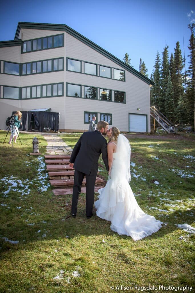 a bride and groom kiss in front of Dante's