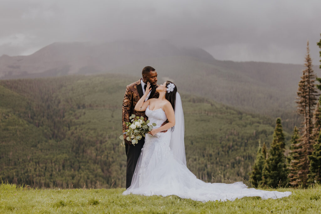 A bride and groom with misty mountains in the background