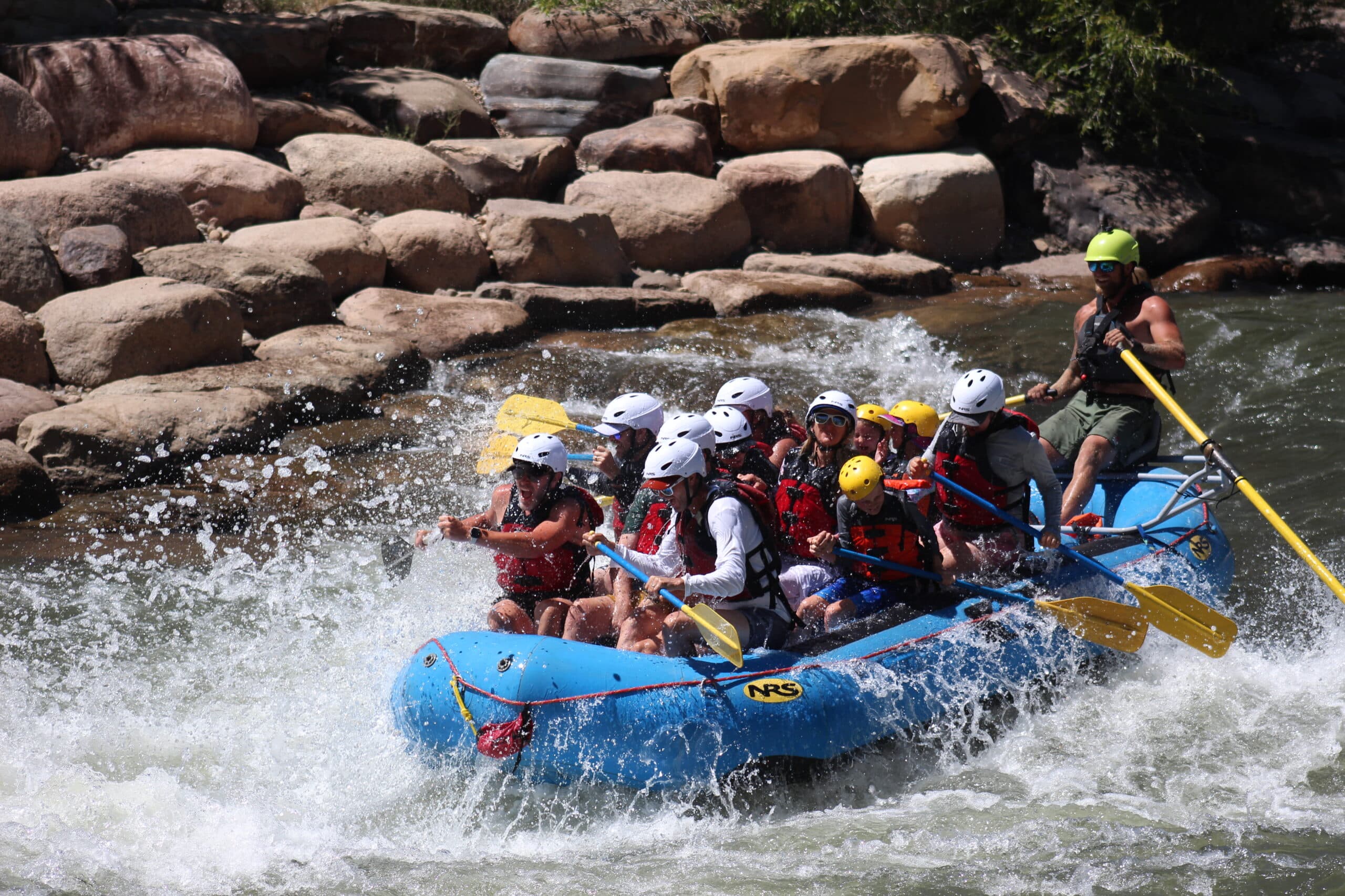 A commercial group of rafters with Colorado Outback Adventure goes through the white water park in Durango, Colorado