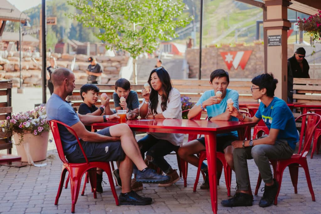 A family eats ice cream on a Purgatory Resort patio