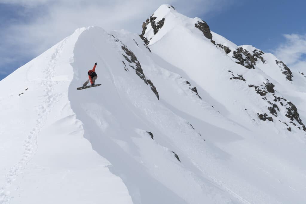 A snowboarder catches air at Valle Nevado