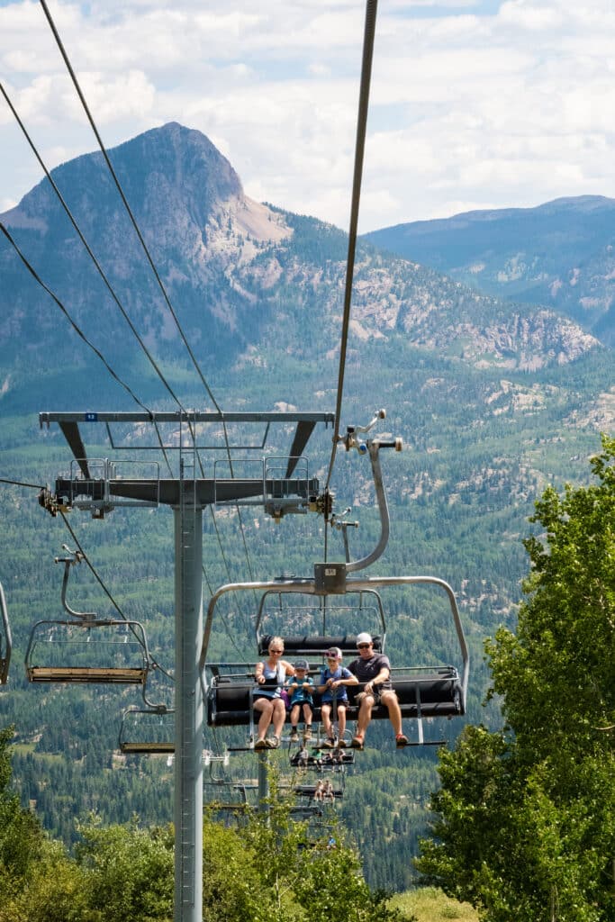 a family rides the scenic chairlift