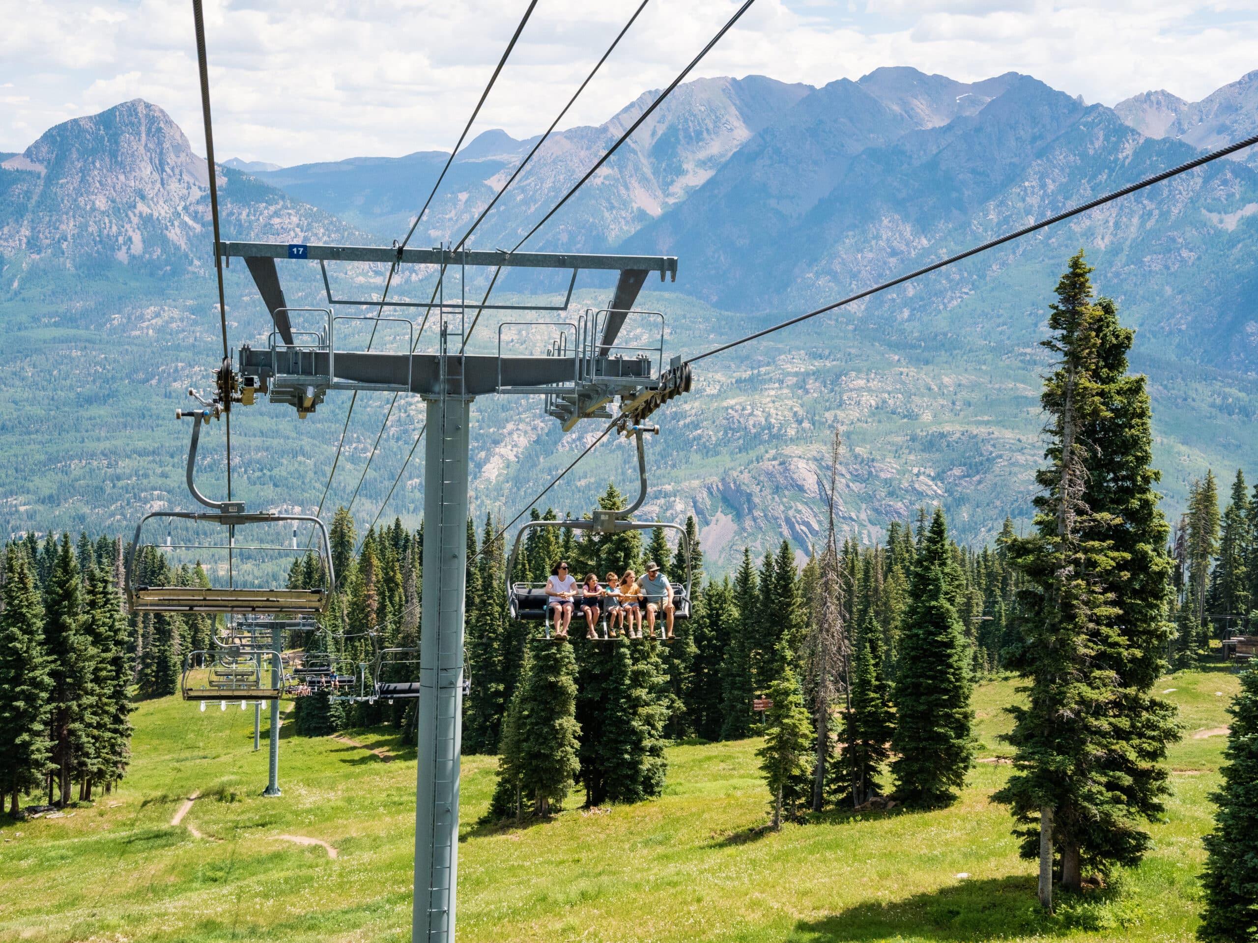 A family rides the scenic chairlift
