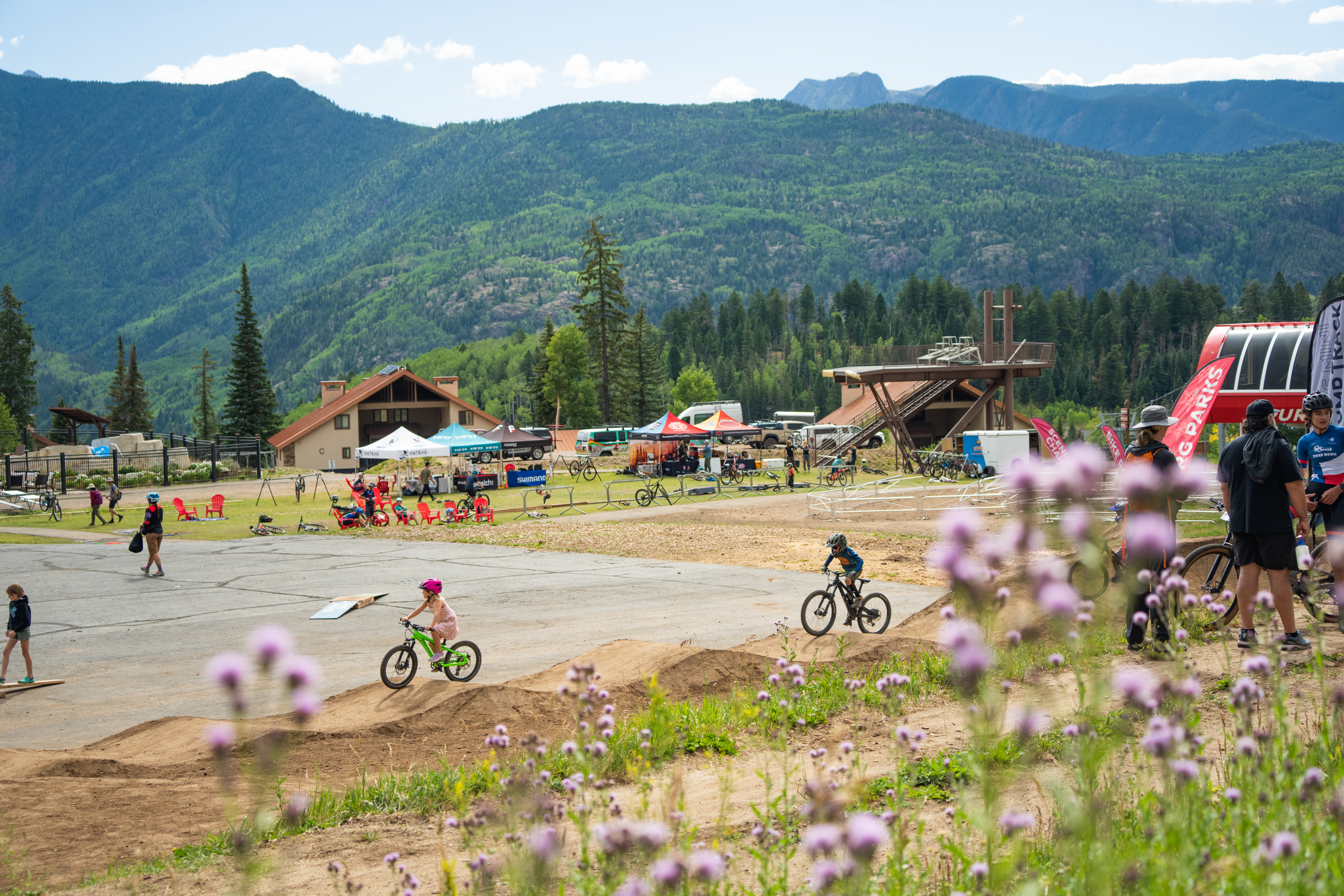 Kids ride bikes around the base area at Purgatory Resort